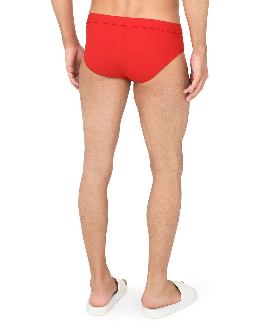 Swim briefs with high-cut leg and branded metal plate