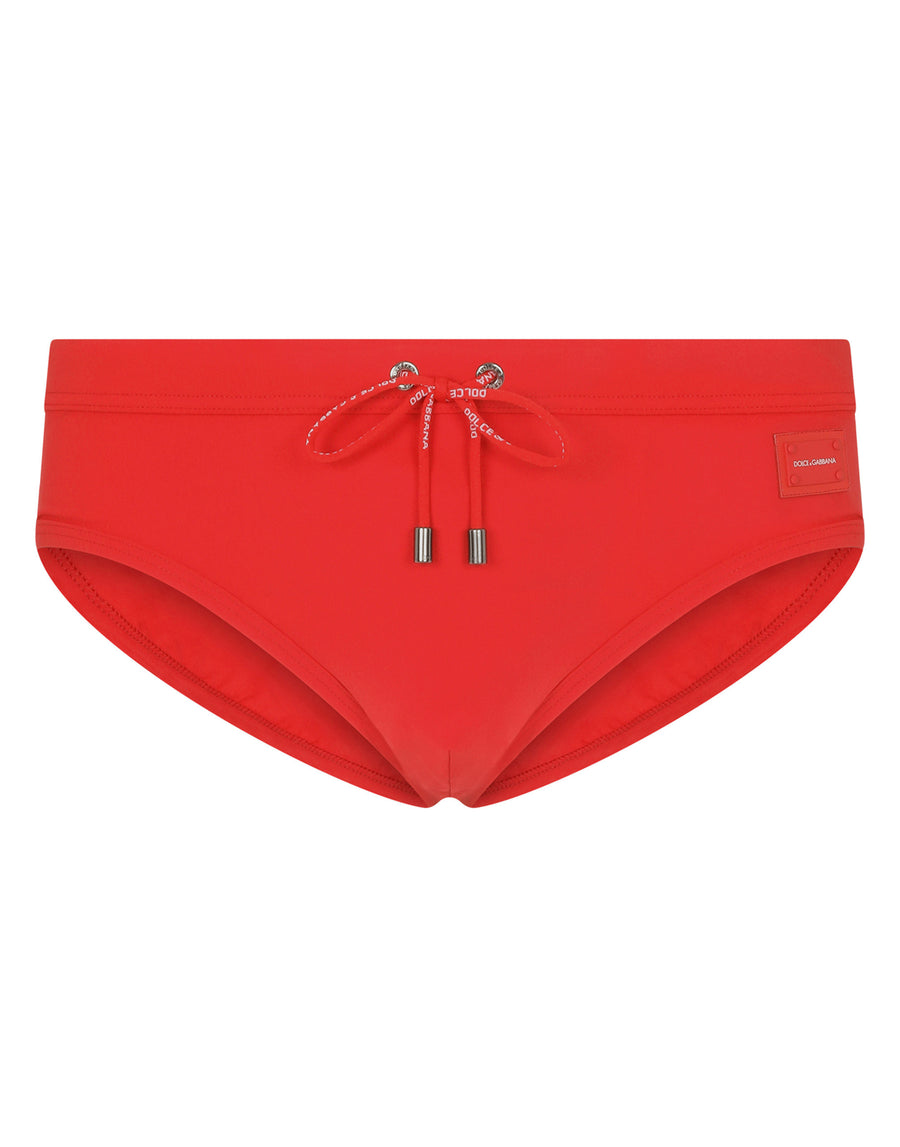 Swim briefs with high-cut leg and branded metal plate