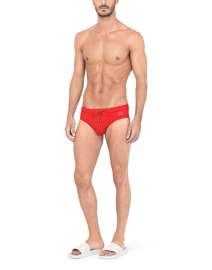 Swim briefs with high-cut leg and branded metal plate