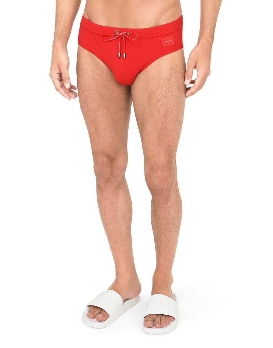 Swim briefs with high-cut leg and branded metal plate